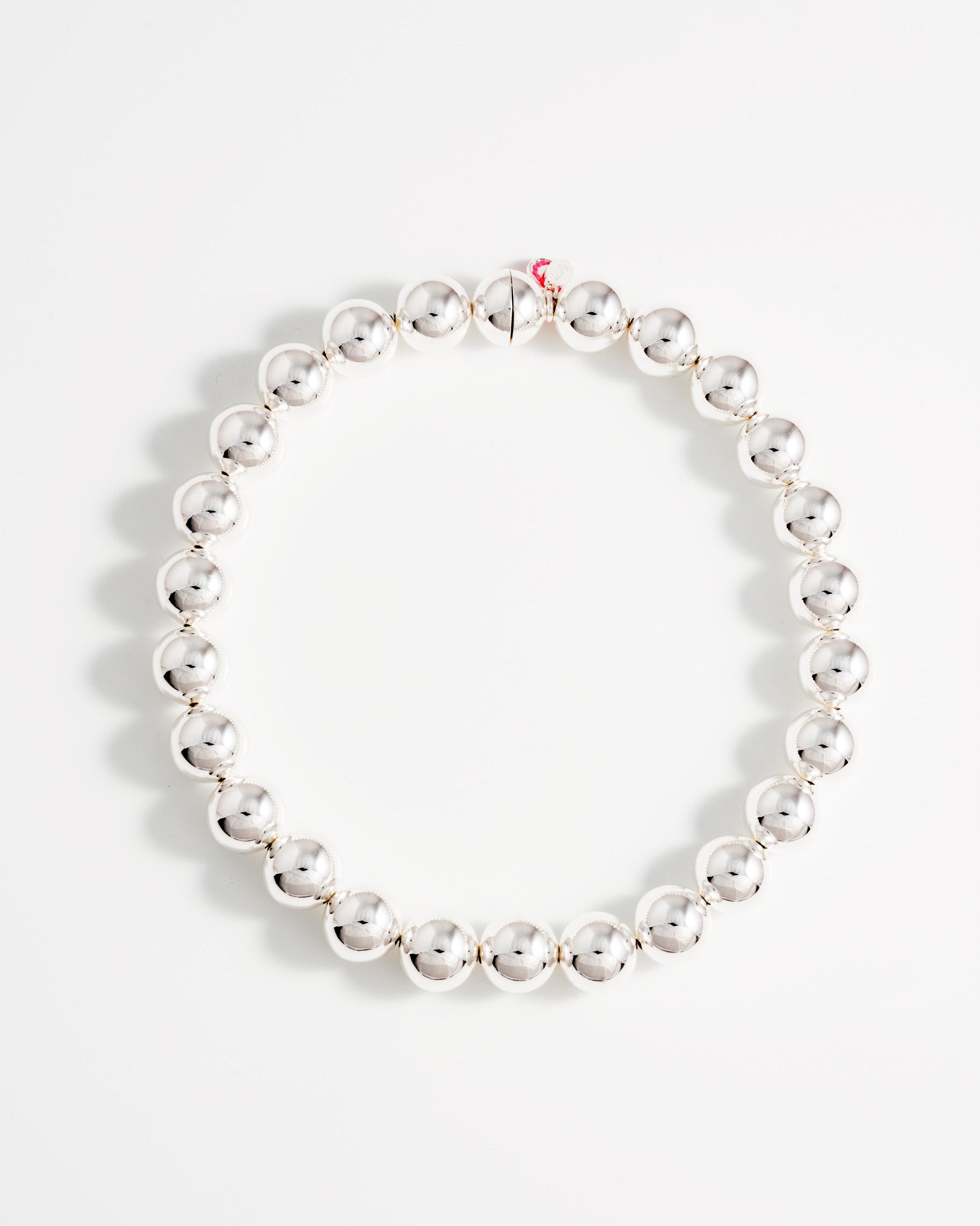 A large silver ball necklace with a magnetic ball closure displayed against a white background.