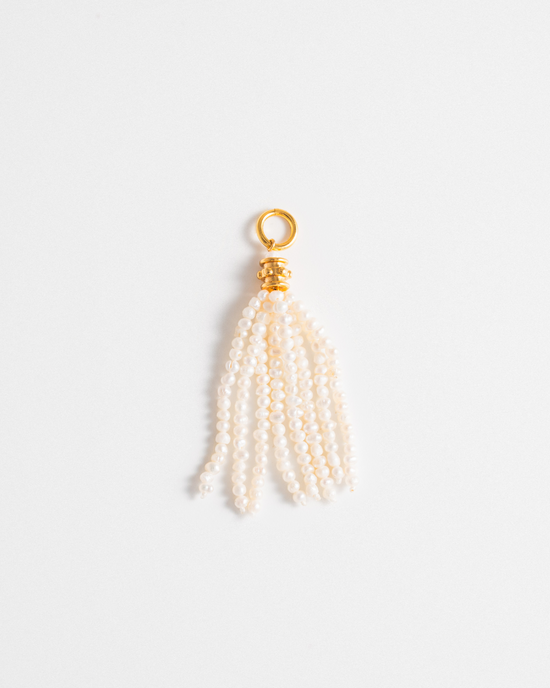 Pearl tassel charm with gold accent on a white background